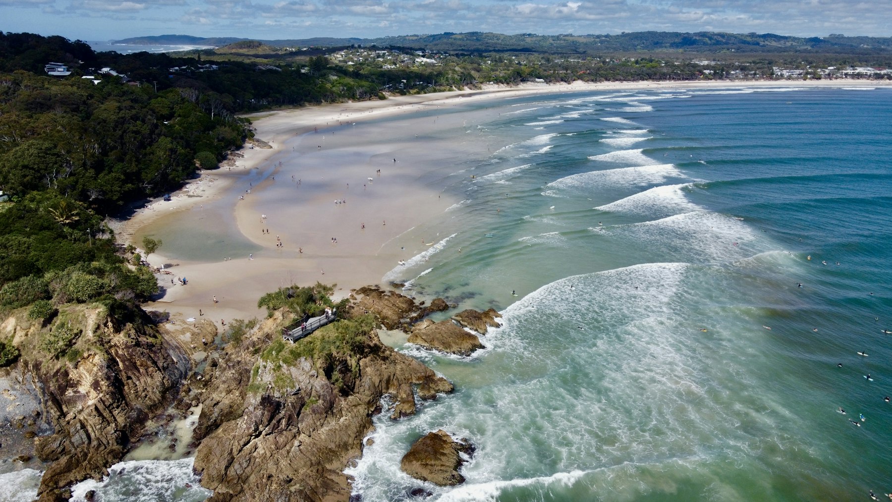 Aerial view of a curved beach and headland