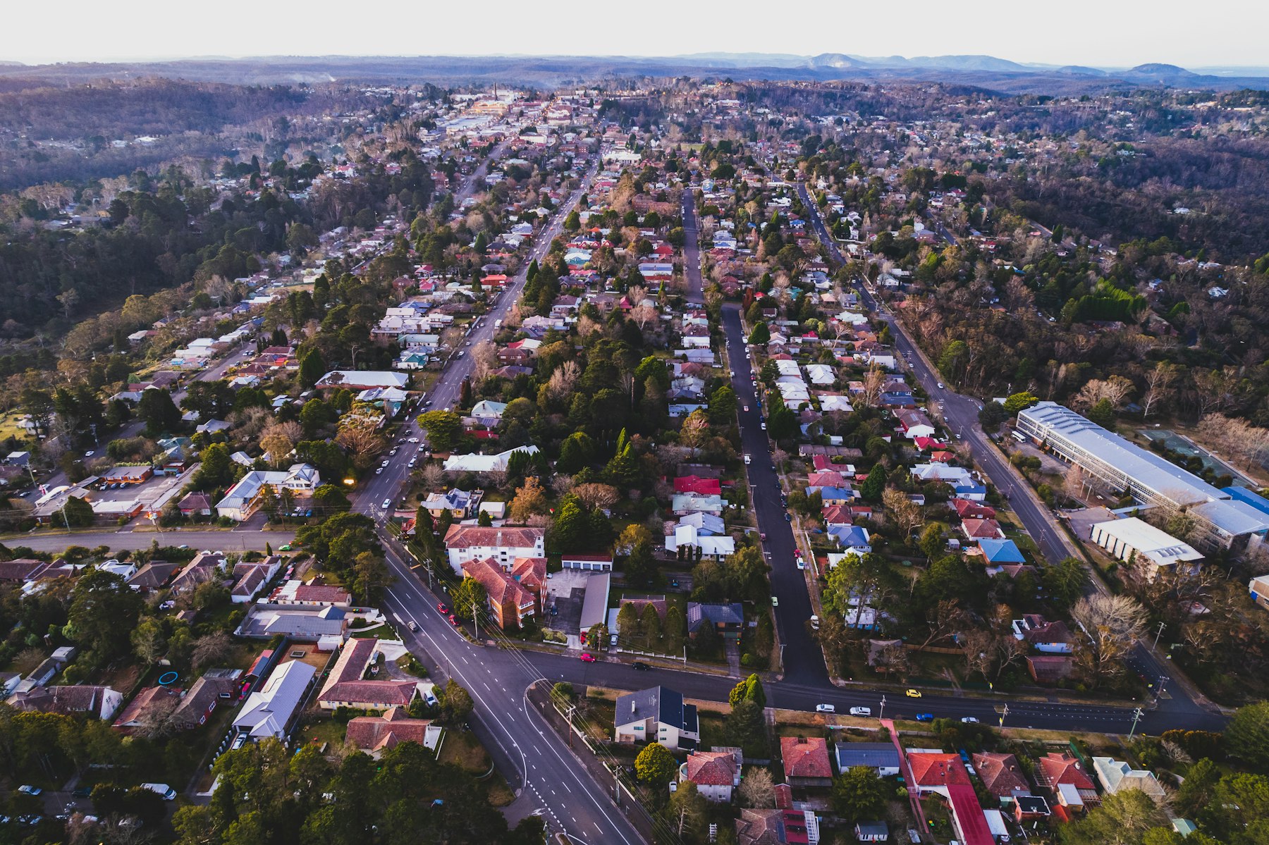 Aerial view of a coastal town with streets and rooftops