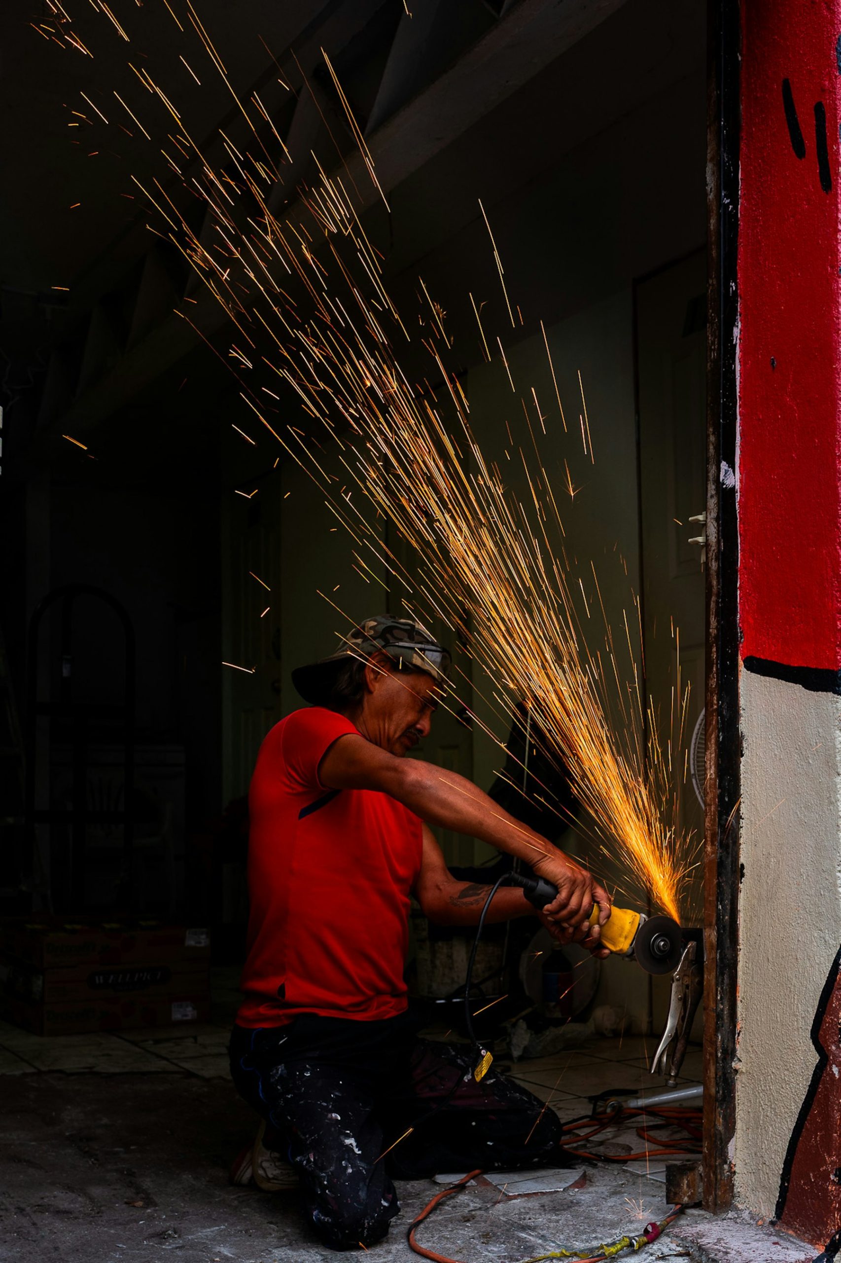 Worker using an angle grinder with sparks